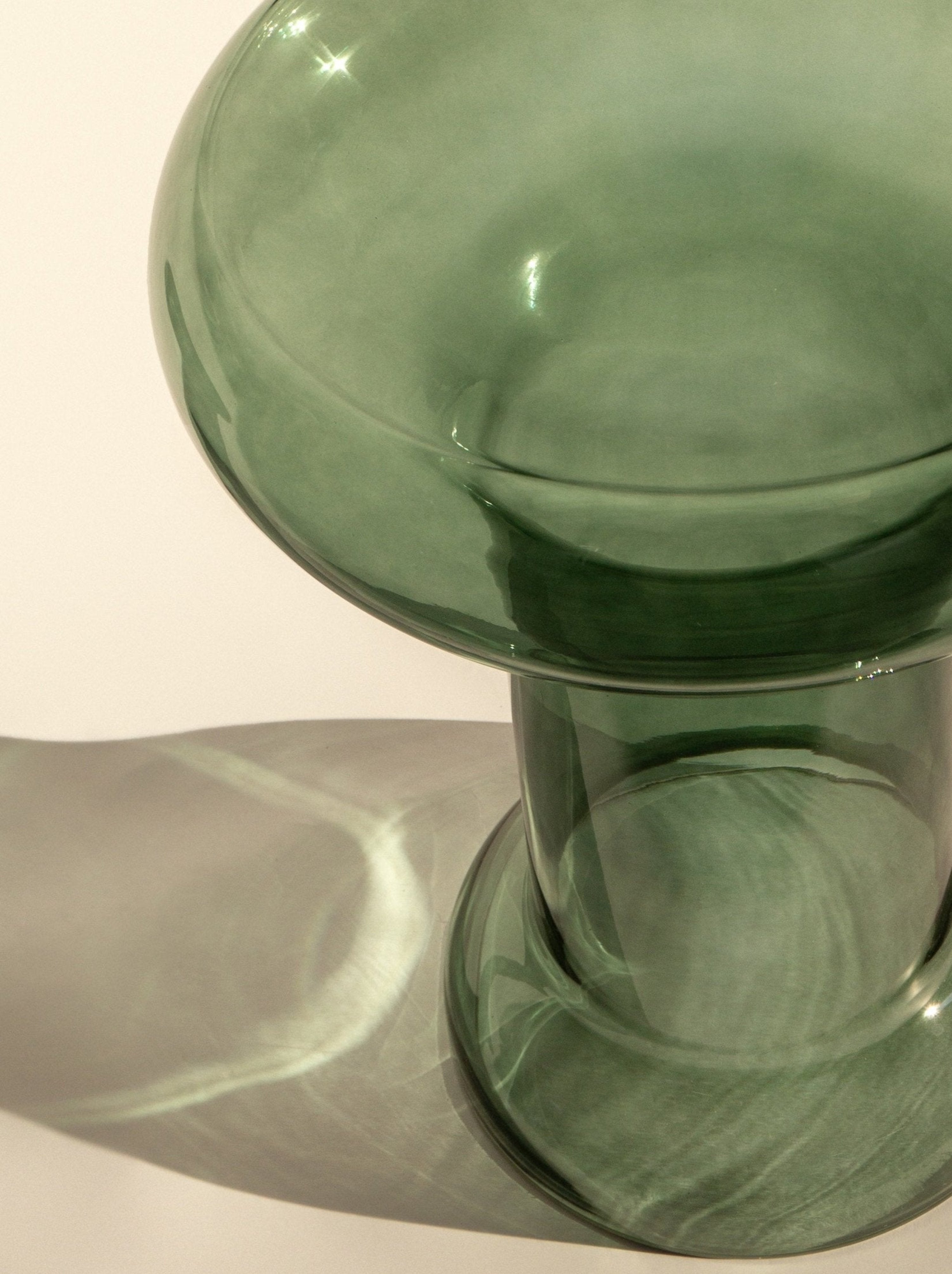 Modern glass accent table with wide top and fluid form – handmade by skilled artisans for a unique statement piece
