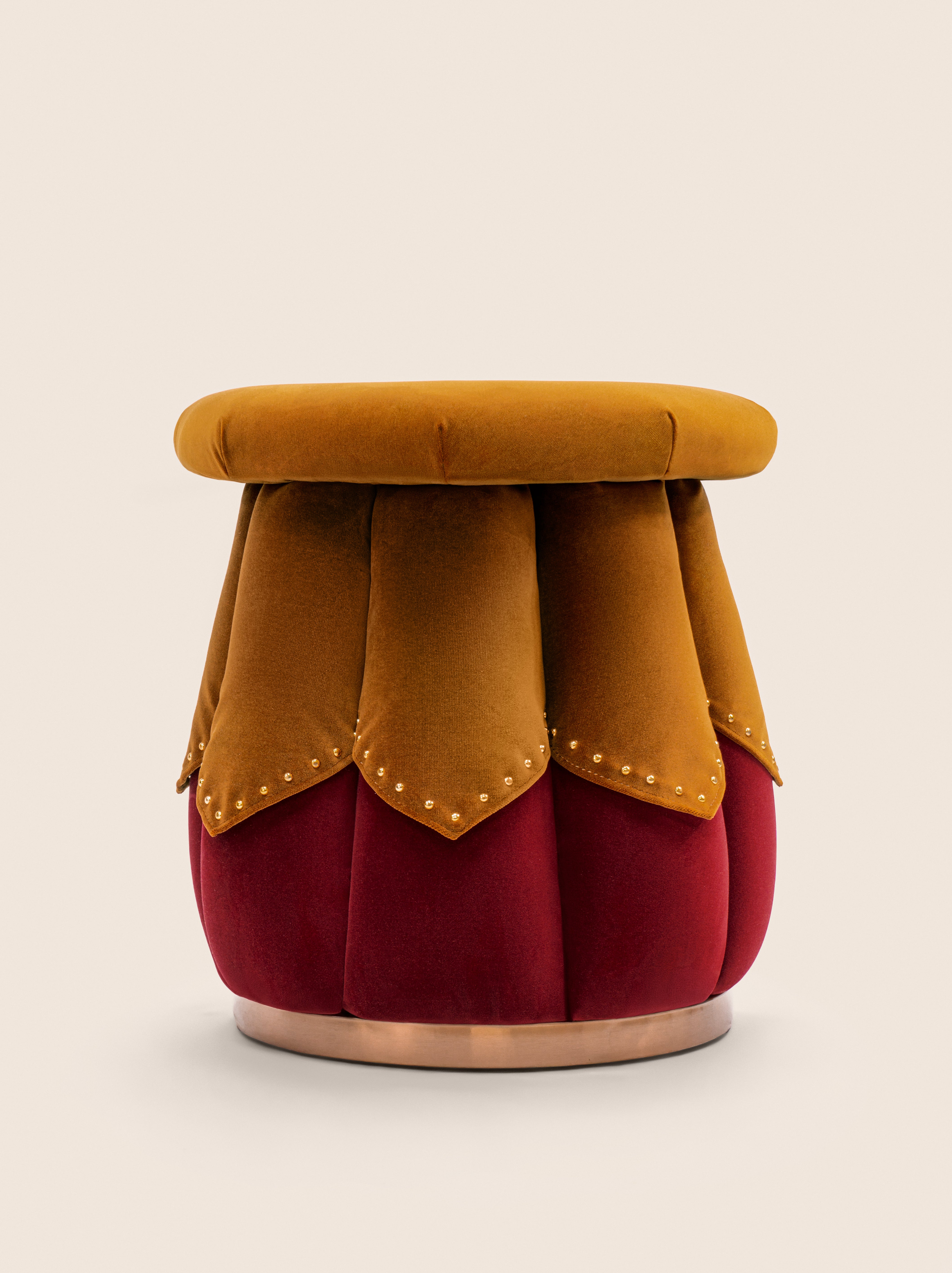 Tulip-inspired velvet ottoman with scalloped base and brass details