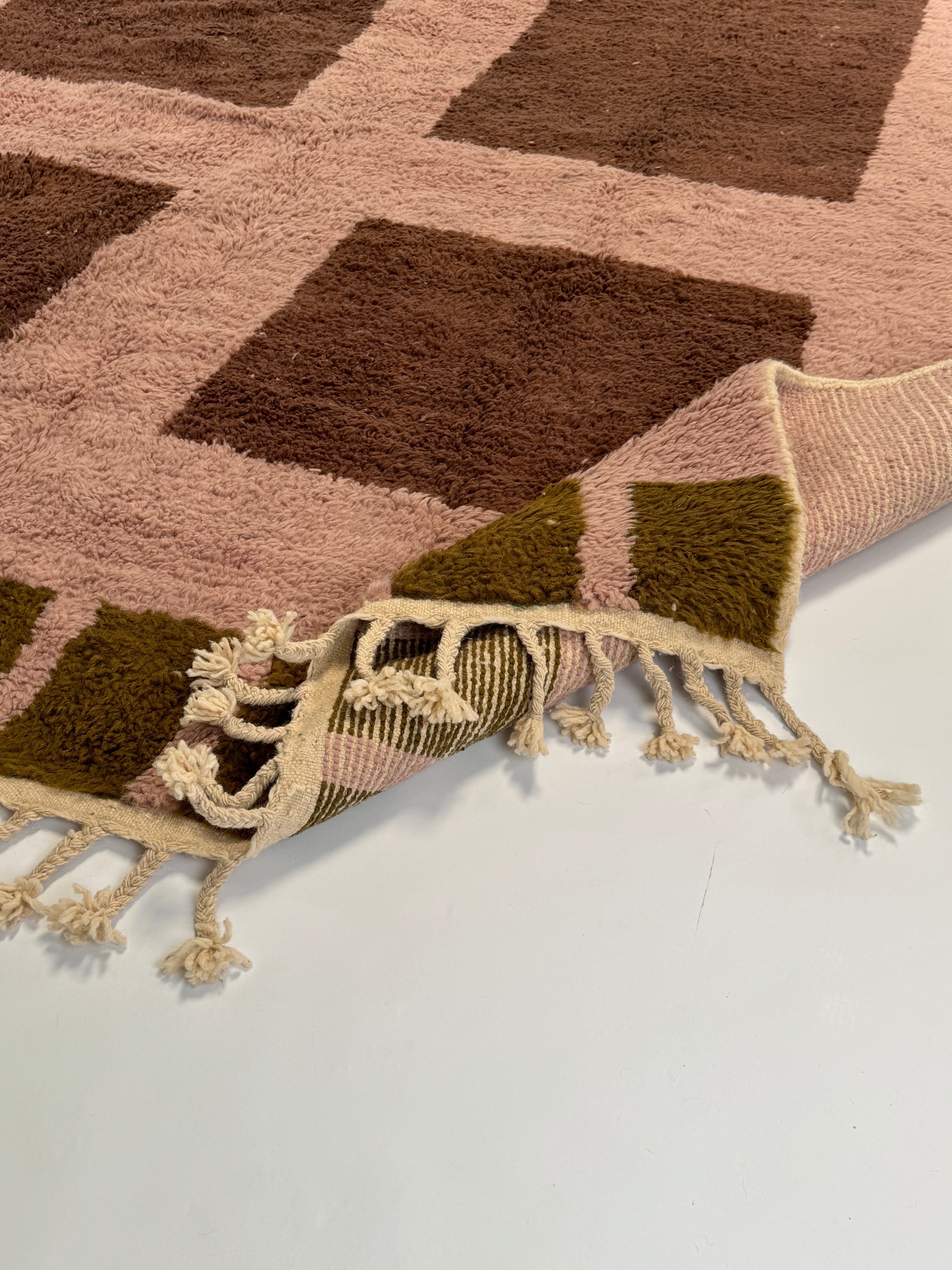 Hand-knotted rug with plush texture and muted geometric design