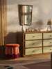 Tulip-inspired velvet ottoman with scalloped base and brass details