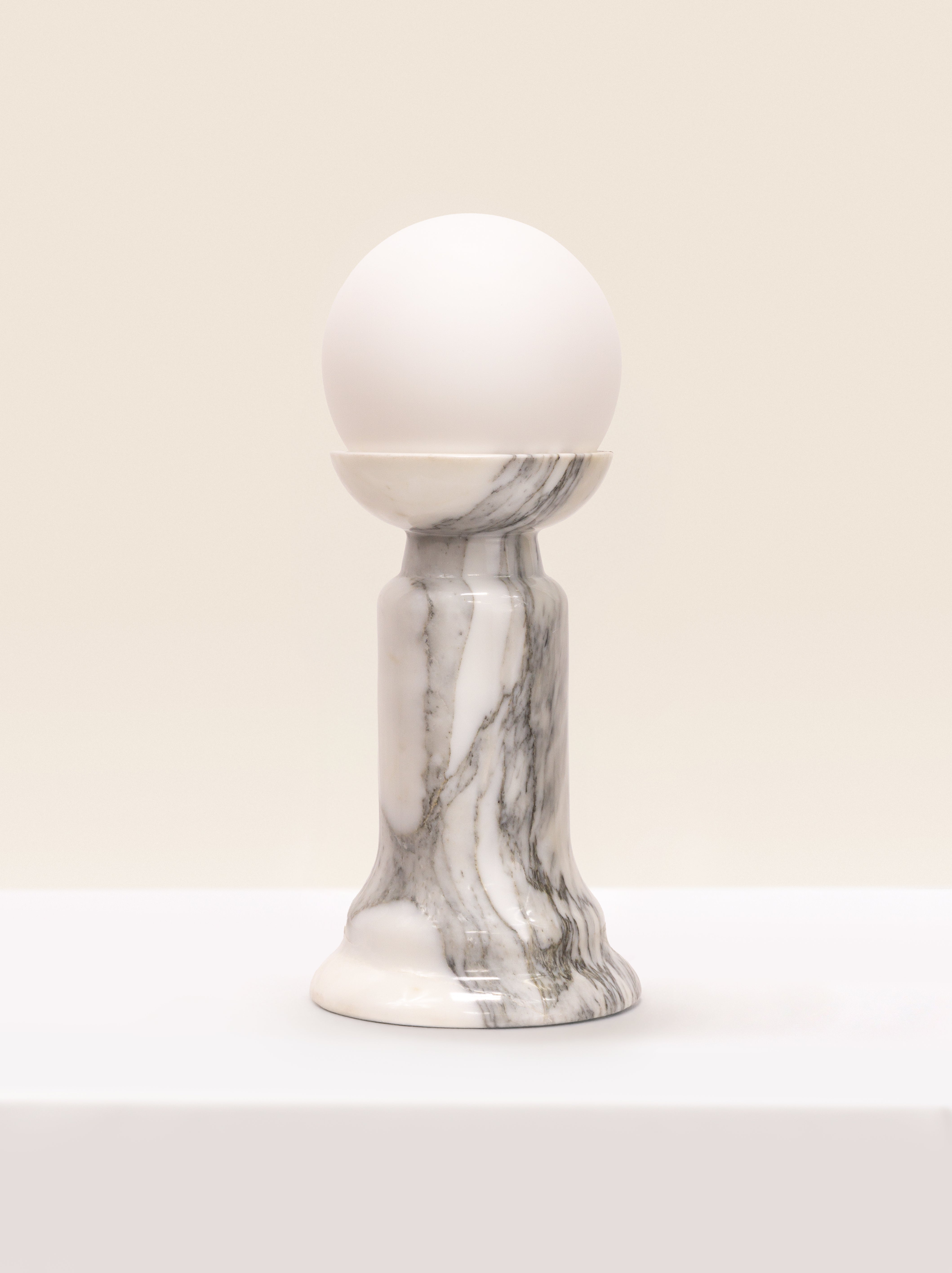 Sculptural white marble table lamp with globe bulb