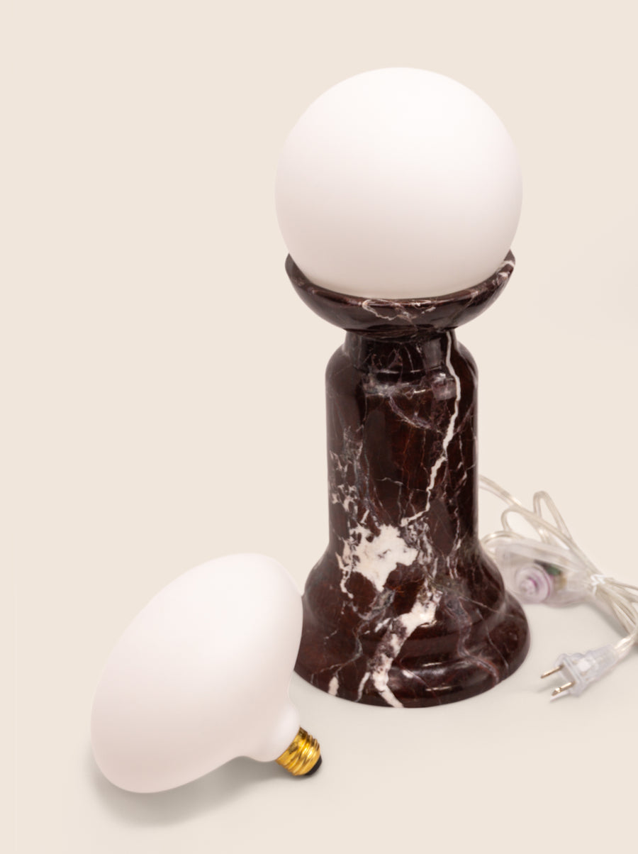 Folsom table lamp with sculptural marble base and glass or globe bulb