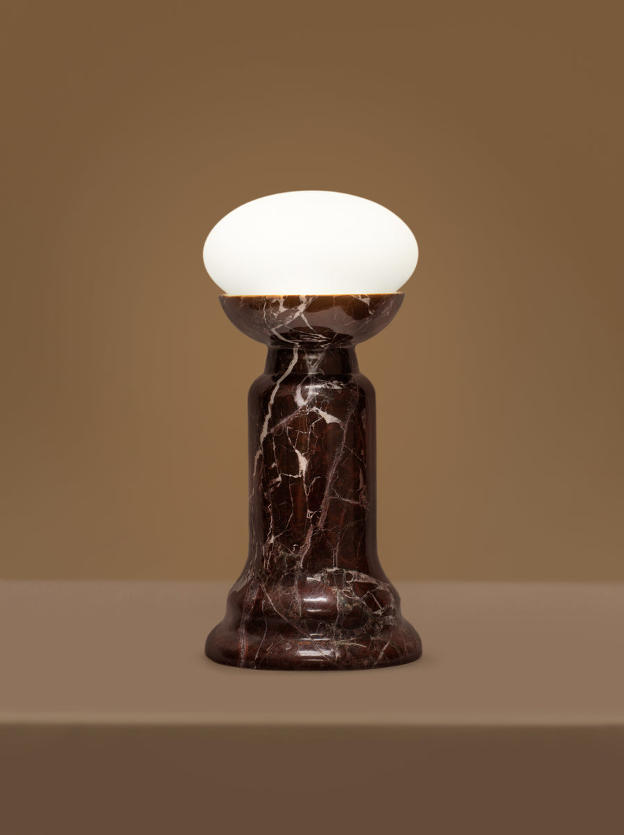 Sculptural Folsom lamp with marble base and glass or globe bulb options.