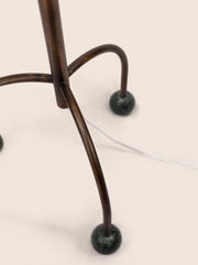 Tripod floor lamp with black frame and playful blue marble spheres
