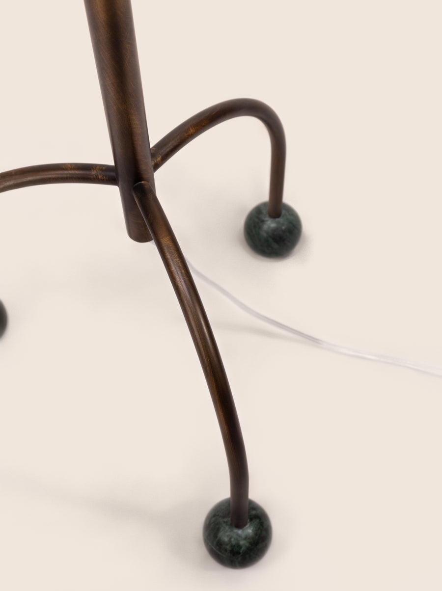 Tripod floor lamp with black frame and playful blue marble spheres