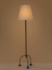 Tripod floor lamp with black frame and playful blue marble spheres