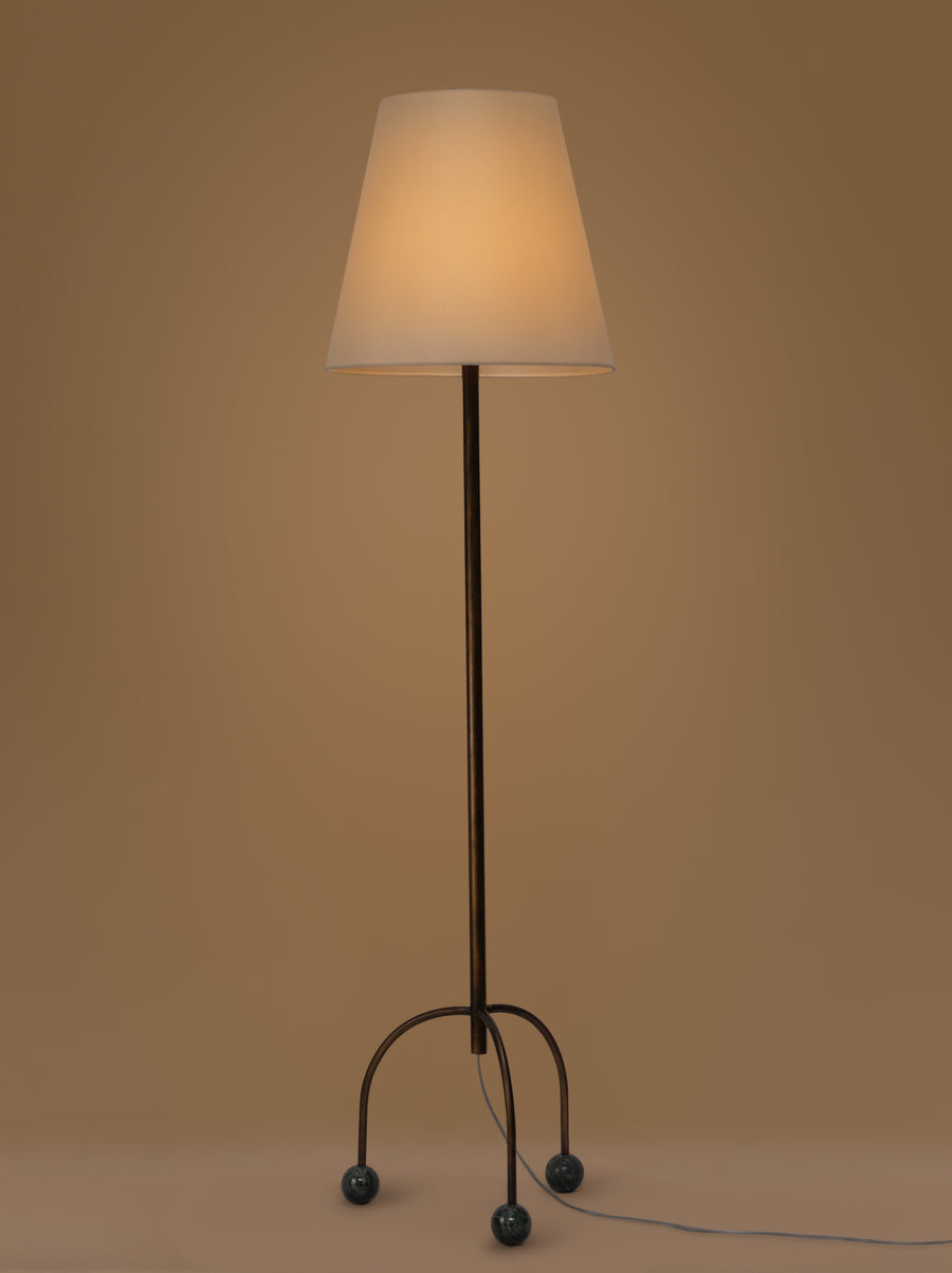 Tripod floor lamp with black frame and playful blue marble spheres