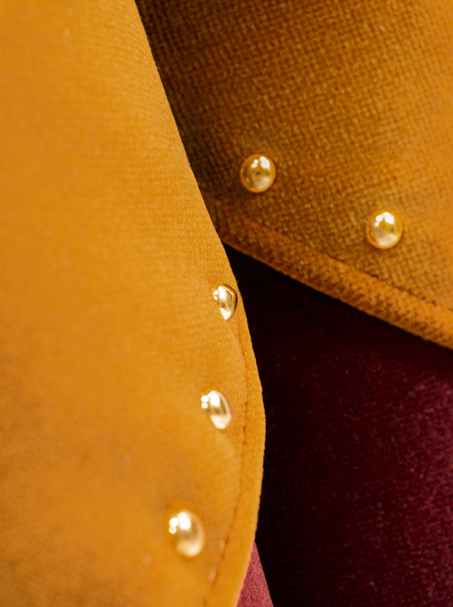 Tulip-inspired velvet ottoman with scalloped base and brass details