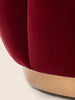 Tulip-inspired velvet ottoman with scalloped base and brass details